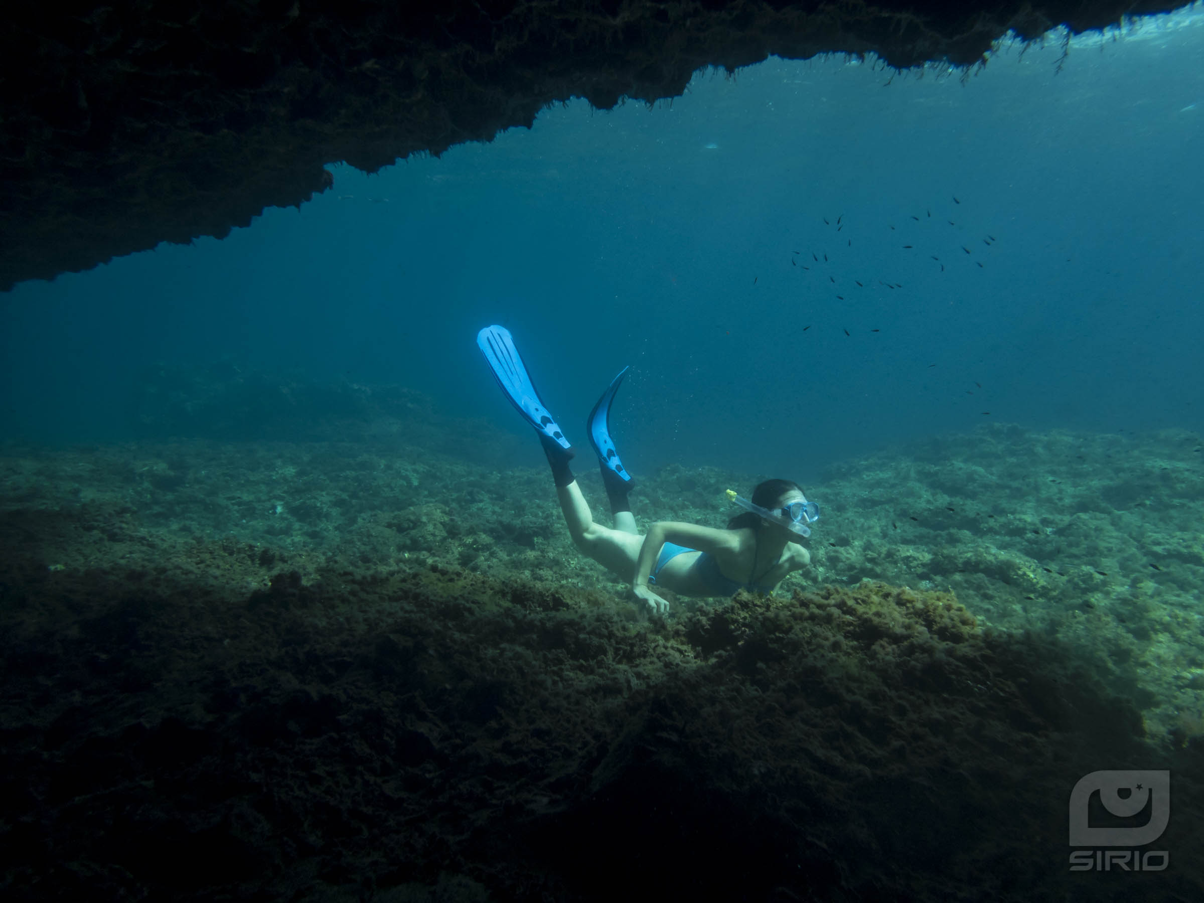 Water cave entrance with girl